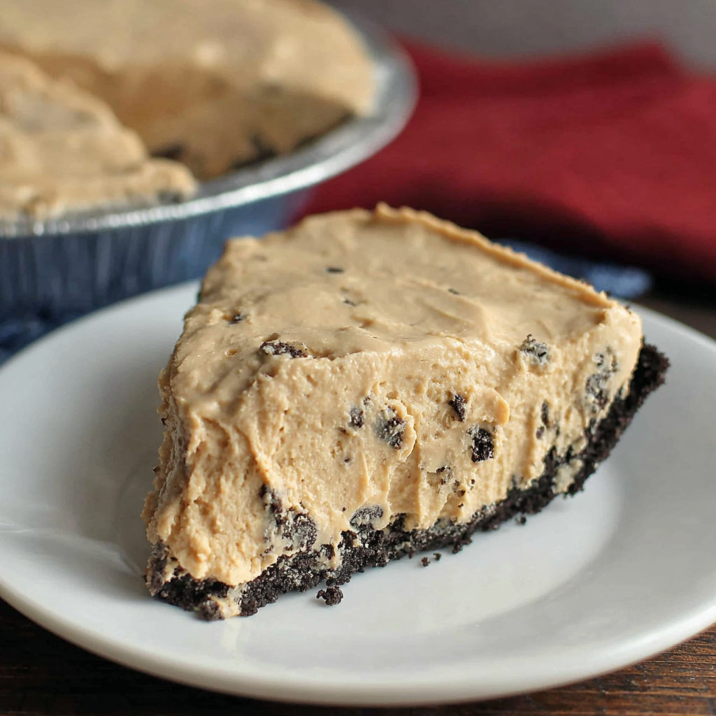 Slice of rock bottom pie with Oreo crust and creamy peanut butter filling