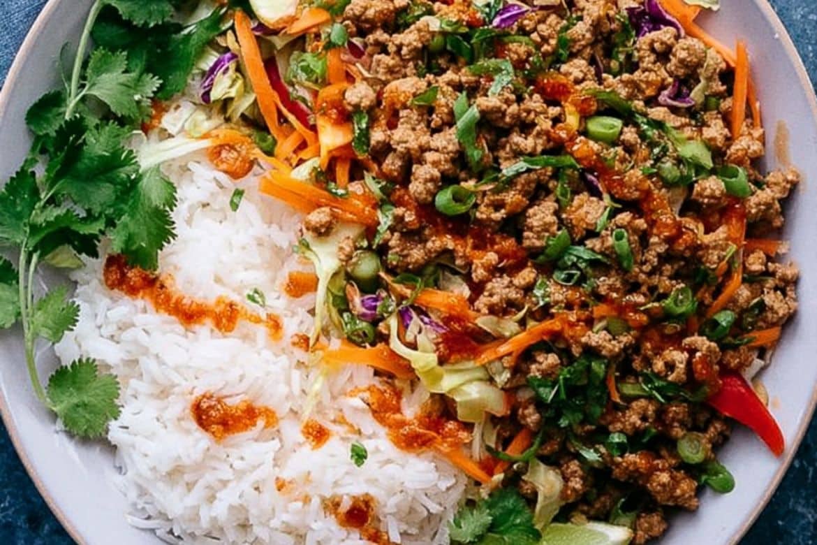 Ground turkey bowl with white rice, cabbage, carrots, and hoisin chili sauce