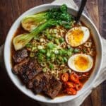 High protein ramen recipe with steak, soft-boiled eggs, and bok choy