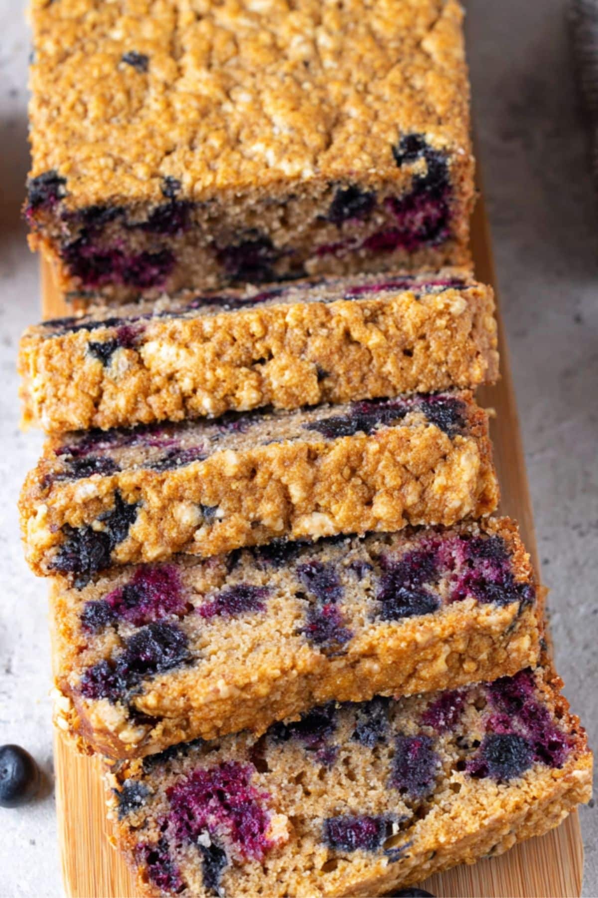 Sliced blueberry oatmeal cottage cheese bread showing juicy blueberries and golden texture