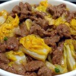 Beef and Napa cabbage stir-fry served in a white bowl