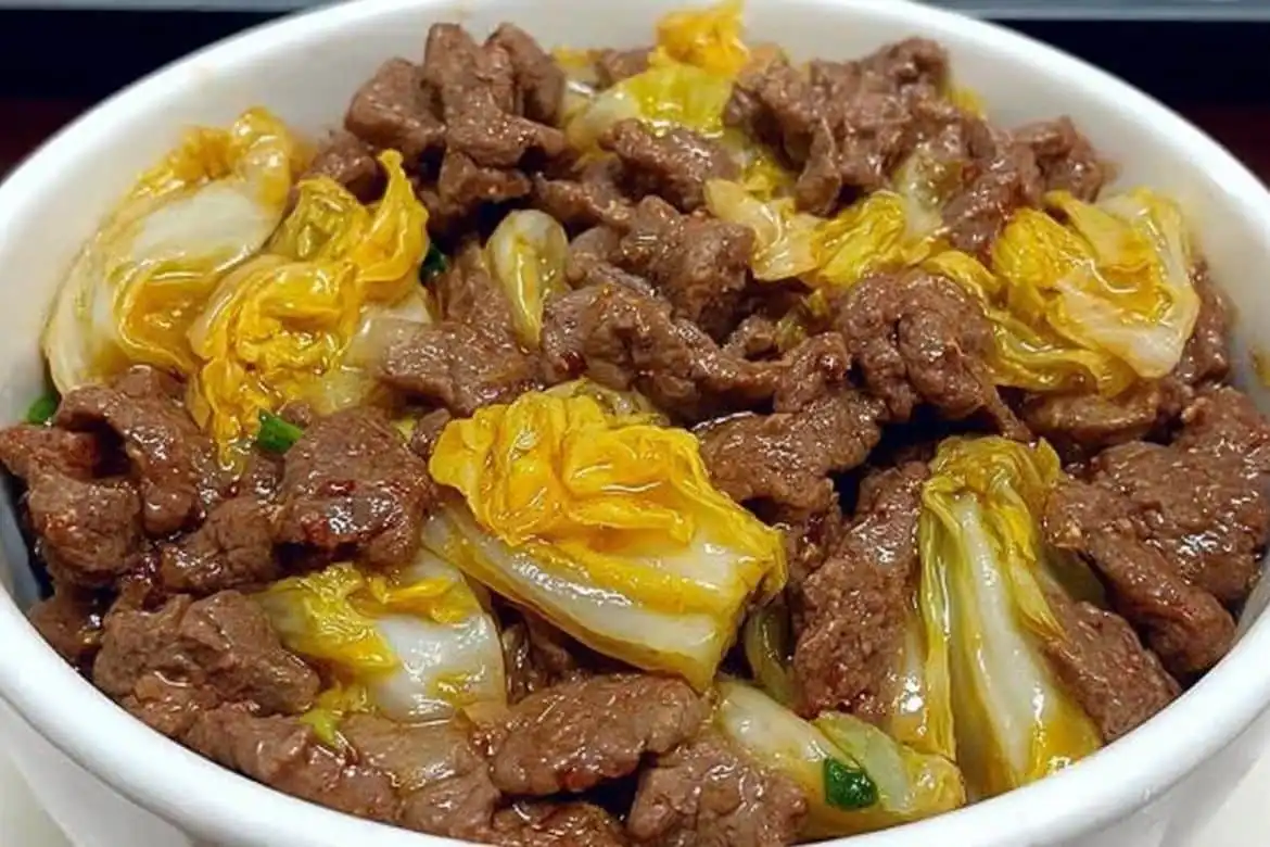 Beef and Napa cabbage stir-fry served in a white bowl