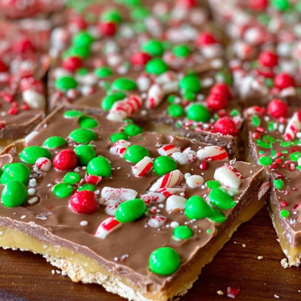 Christmas Crack recipe topped with crushed peppermint and green and red holiday candies