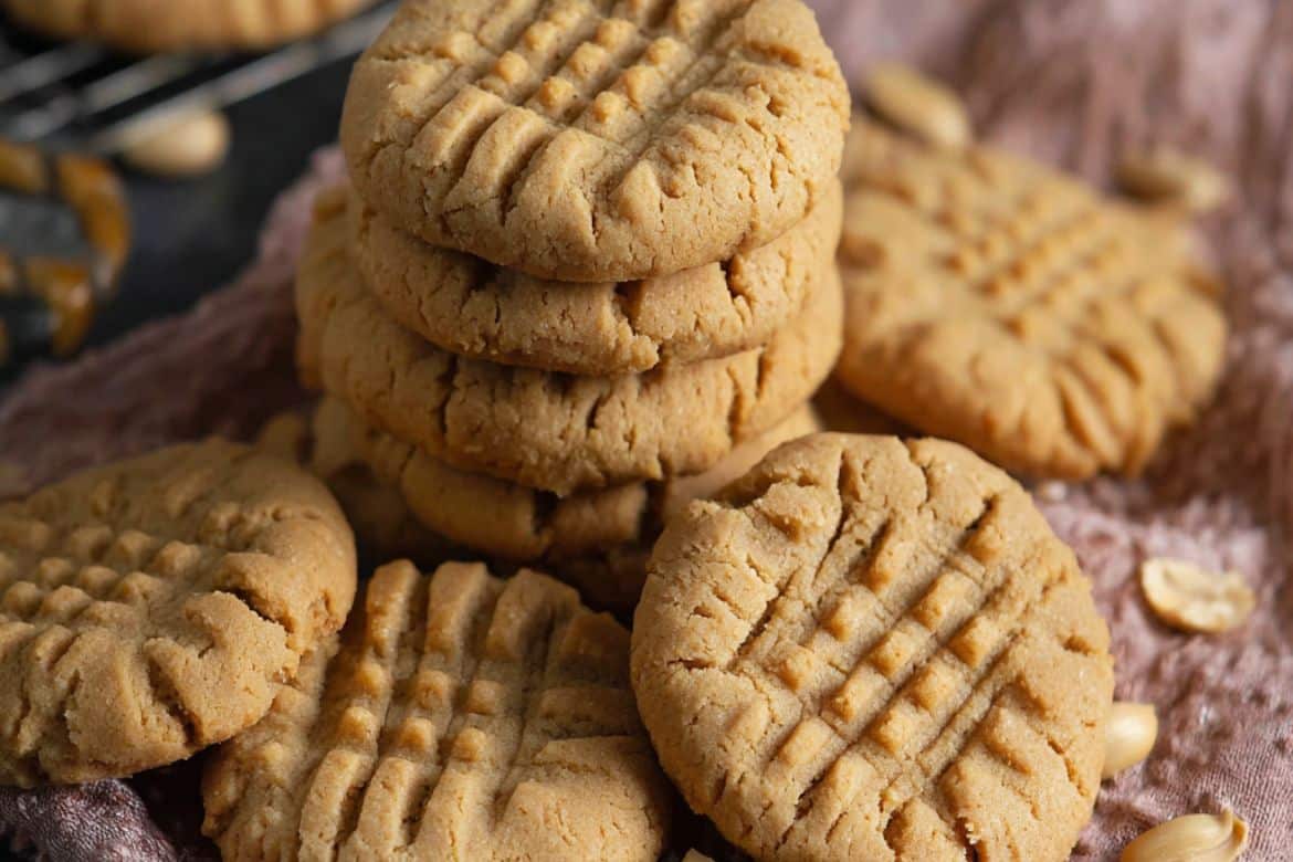 Soft peanut butter cookies stacked on a plate
