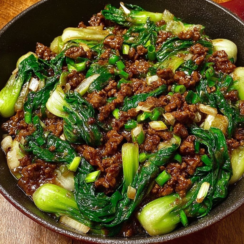 bowl of stir-fried bok choy with beef and green onions