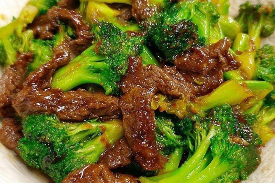 Beef and broccoli stir fry served in a bowl with savory sauce