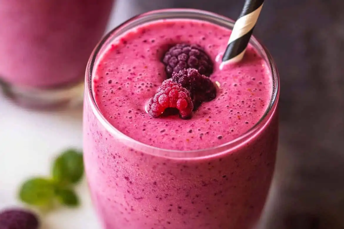 Berry Peanut Butter Smoothie in tall glass with straw