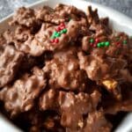 Crockpot Christmas Crack candy clusters topped with red and green sprinkles
