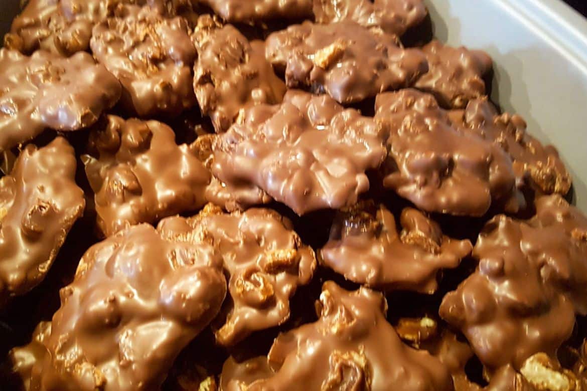 Crockpot Christmas Crack peanut clusters cooling on tray