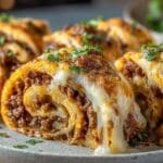 Garlic Butter Cheeseburger Rollups close up with melted cheese and beef filling