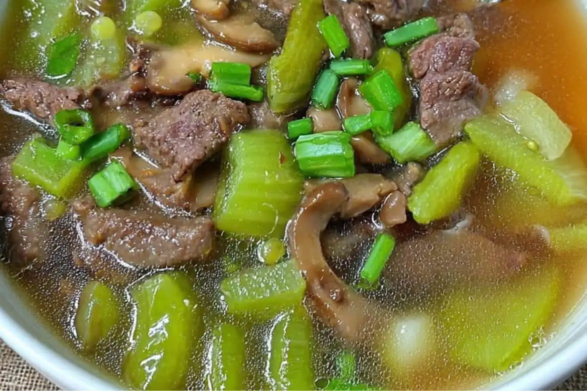 Beef Patola and Mushroom Soup with sliced beef, patola, mushrooms, and green onion in clear garlic-soy broth