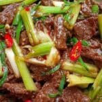 Beef and celery stir-fry with red chili and green onion in savory sauce