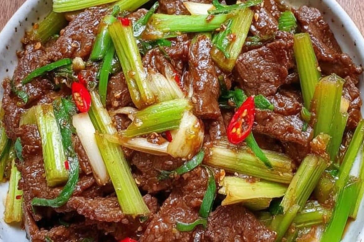Beef and celery stir-fry with red chili and green onion in savory sauce