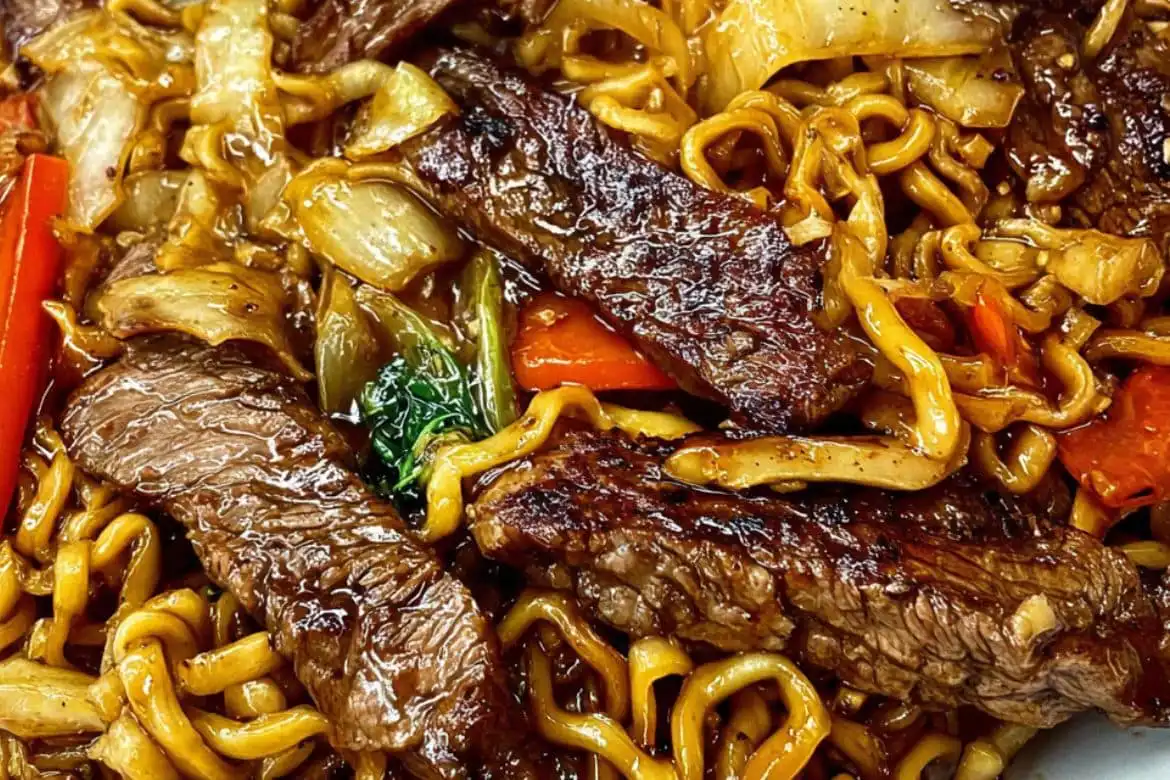 Steak stir-fried ramen with glossy noodles, vegetables, and seared beef