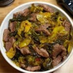 Bowl of stir-fried beef with pickled mustard greens in savory sauce