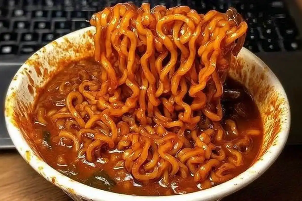 Spicy ramen noodle recipe in a bowl with thick red chili sauce