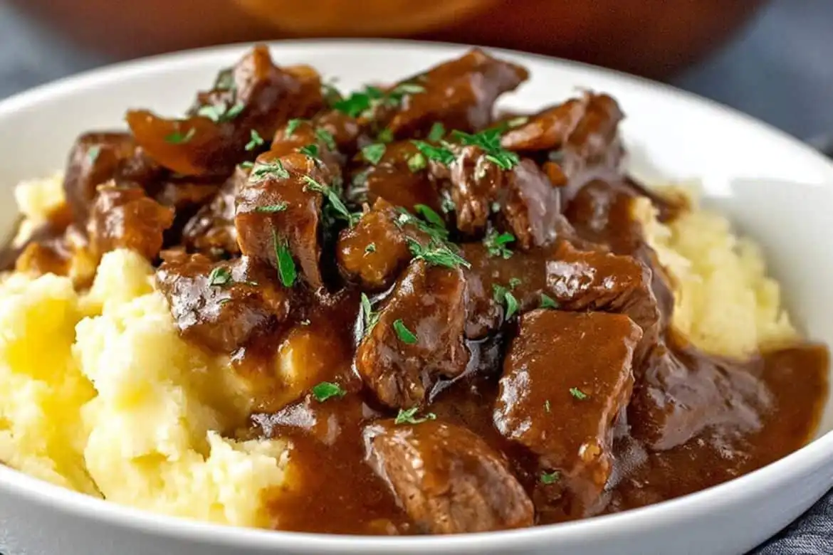 Beef tips in rich brown gravy served over mashed potatoes