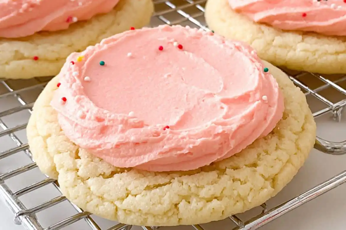 Soft Crumbl Sugar Cookie topped with pink almond frosting and sprinkles