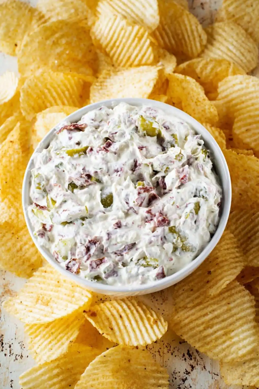 Bowl of Pickle Wrap Dip served with ridged potato chips