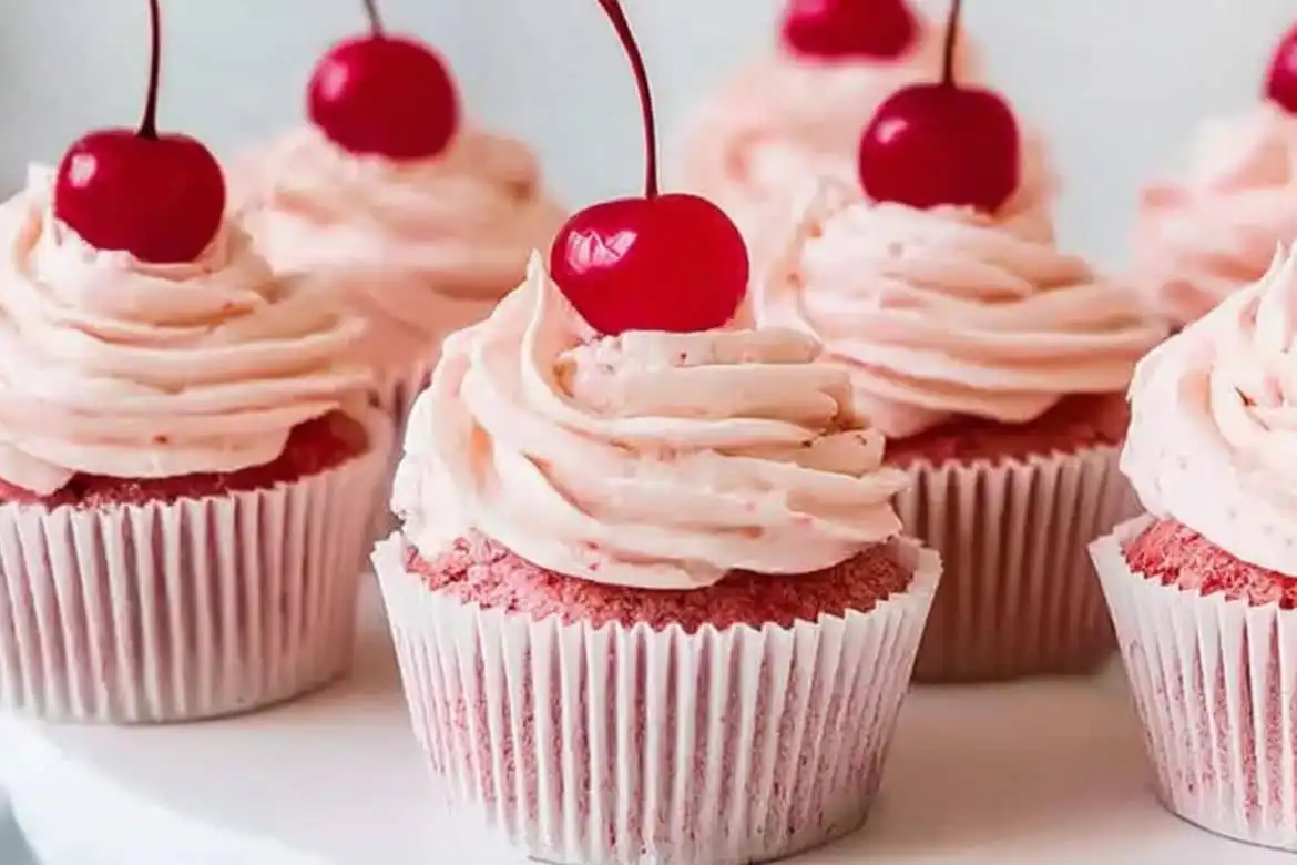Cherry cupcakes with pink frosting and maraschino cherry topping