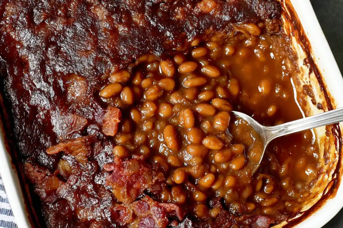 Baked beans recipe from canned beans in a white casserole dish