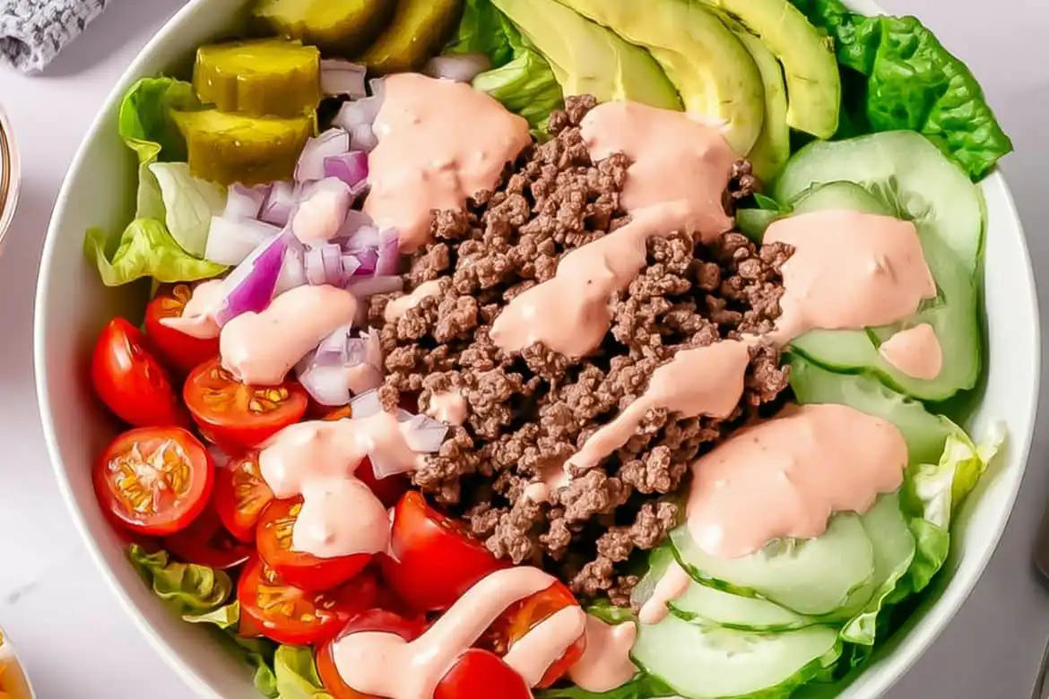 Burger Bowls with Special Sauce topped with ground beef, avocado, cherry tomatoes, pickles, and creamy sauce