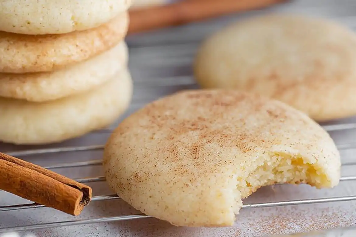 Old fashioned tea cake with cinnamon on cooling rack, one with bite taken
