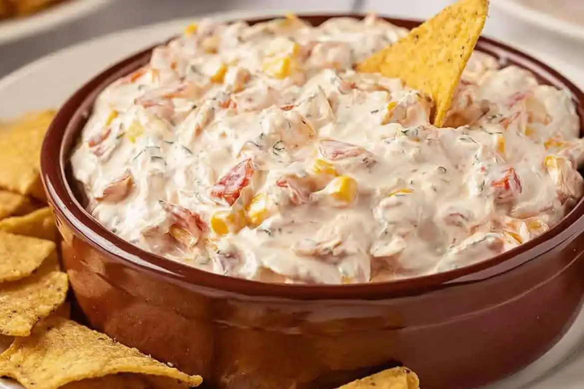 Boat dip rotel ranch dip in a brown serving bowl with tortilla chips
