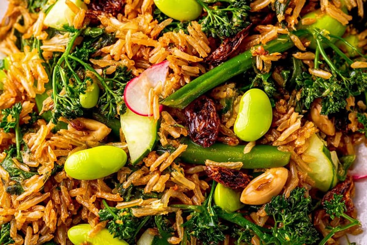 Crispy rice salad with edamame, broccoli, radishes, peanuts, and fresh herbs